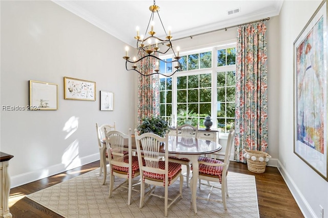 dining room with crown molding, dark hardwood / wood-style flooring, and a chandelier