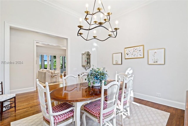 dining space with a notable chandelier, crown molding, and dark hardwood / wood-style floors