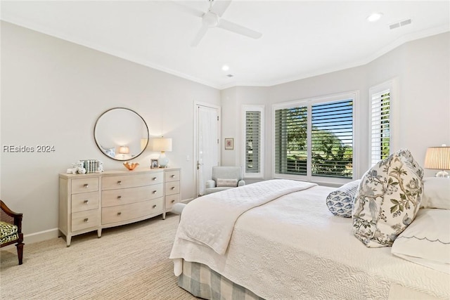 bedroom featuring crown molding, ceiling fan, light colored carpet, and a closet