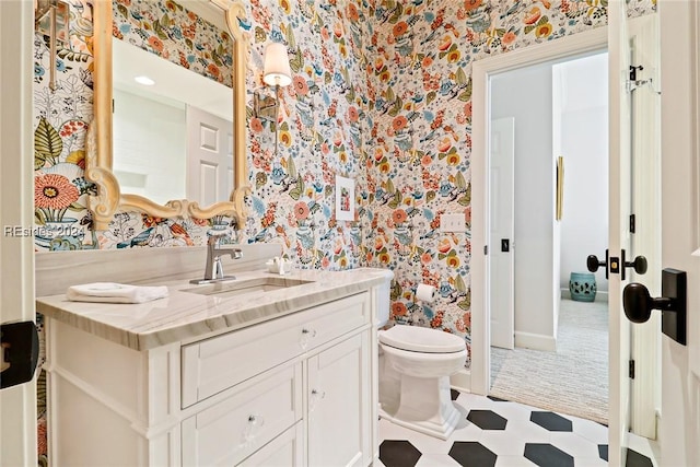 bathroom featuring vanity and toilet