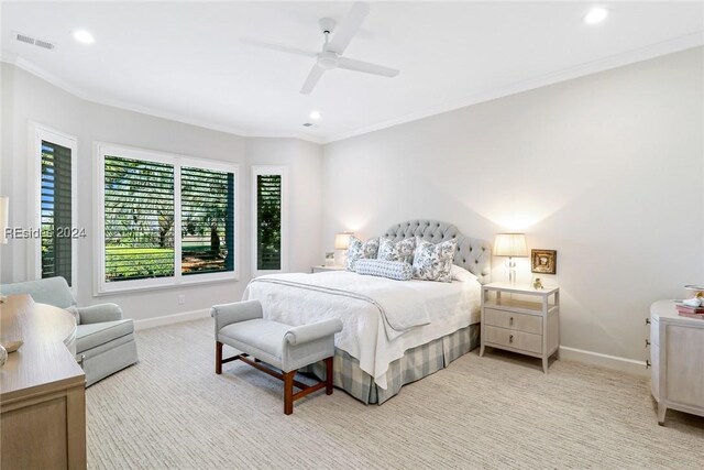 bedroom featuring crown molding, light colored carpet, and ceiling fan