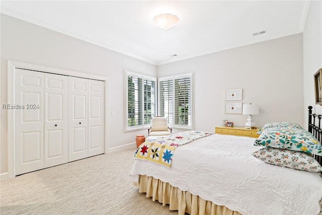 carpeted bedroom with ornamental molding and a closet