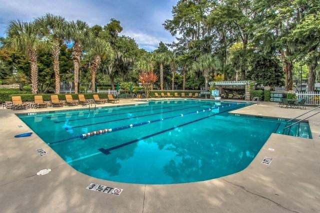 view of swimming pool with a patio and a pergola