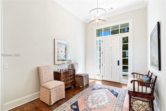 entrance foyer featuring a high ceiling, dark wood-type flooring, and a notable chandelier