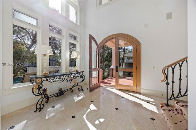 entrance foyer with a towering ceiling and french doors