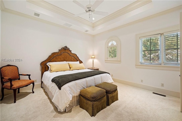 bedroom with light carpet, a tray ceiling, ornamental molding, and ceiling fan