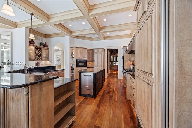 kitchen featuring pendant lighting, sink, coffered ceiling, a kitchen island, and oven