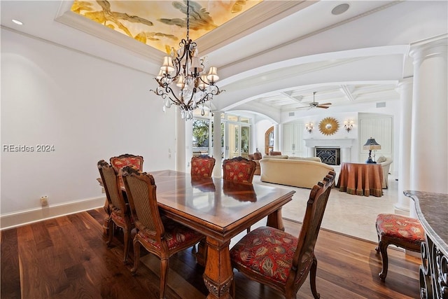 dining space with decorative columns, wood-type flooring, and coffered ceiling