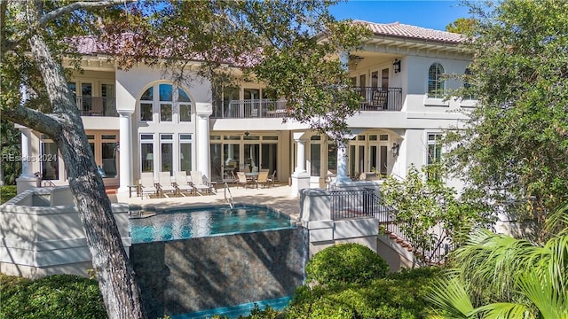 back of property with a patio and a balcony