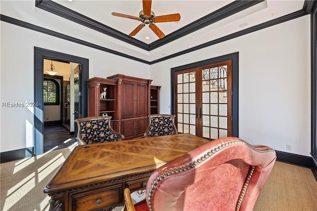 carpeted dining space featuring ornamental molding, french doors, and a raised ceiling