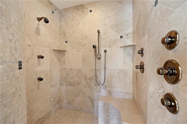 bathroom with a tile shower