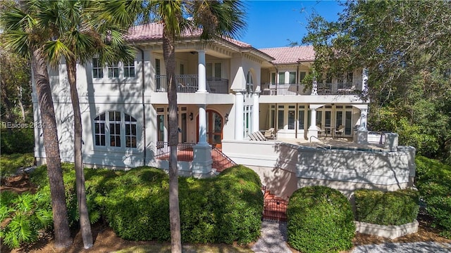 mediterranean / spanish home featuring french doors and a balcony