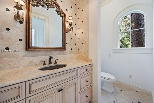 bathroom featuring ornamental molding, vanity, toilet, and tile patterned flooring