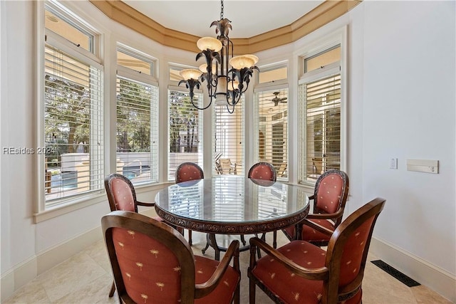 tiled dining room featuring a chandelier and a wealth of natural light