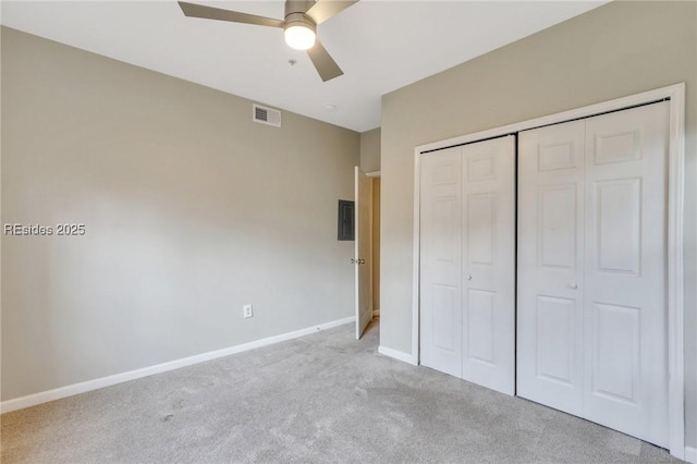 unfurnished bedroom with light colored carpet, ceiling fan, and a closet