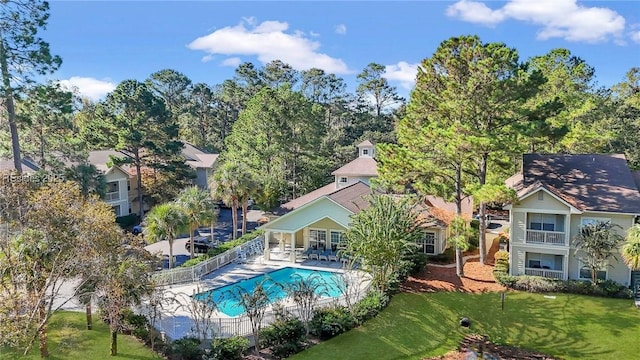 view of swimming pool featuring a patio and a lawn