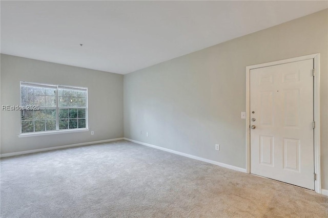 spare room featuring light colored carpet