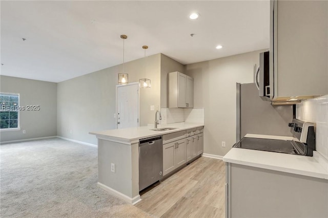 kitchen with sink, gray cabinets, stainless steel appliances, and hanging light fixtures