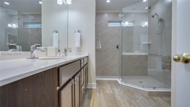 bathroom with vanity and a shower with shower door