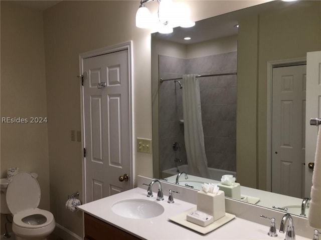 full bathroom featuring vanity, shower / tub combo, and toilet