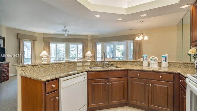 kitchen featuring sink, white appliances, plenty of natural light, and kitchen peninsula