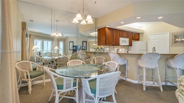 carpeted dining room with a notable chandelier