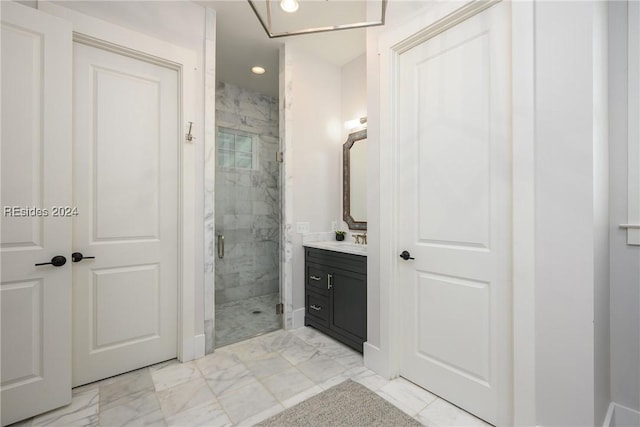 bathroom featuring vanity and a shower with door