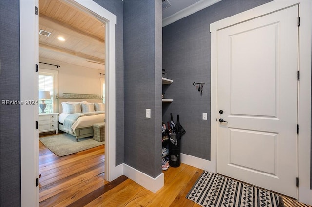 interior space with wood ceiling, beam ceiling, and hardwood / wood-style floors