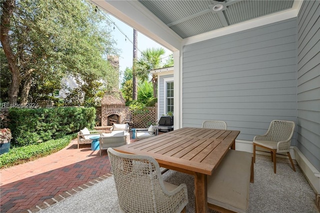 view of patio / terrace with an outdoor living space with a fireplace