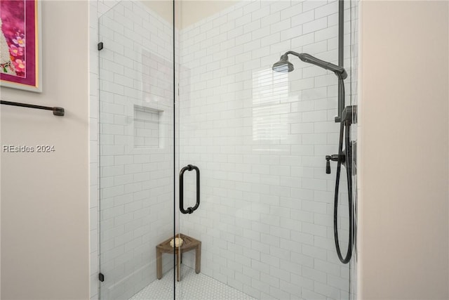 bathroom with a shower with shower door