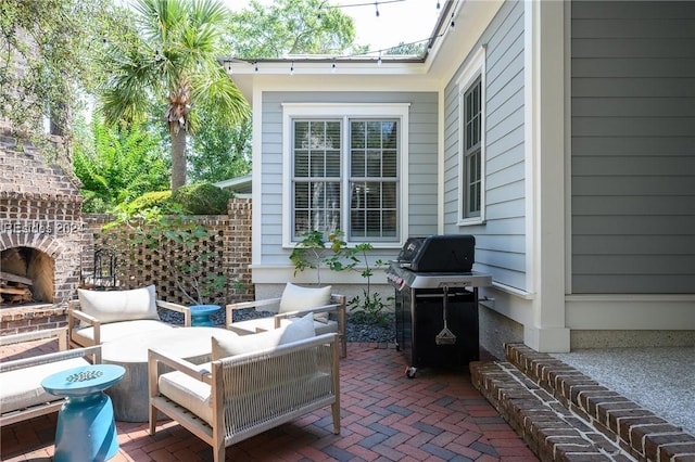 view of patio / terrace featuring an outdoor living space with a fireplace and area for grilling