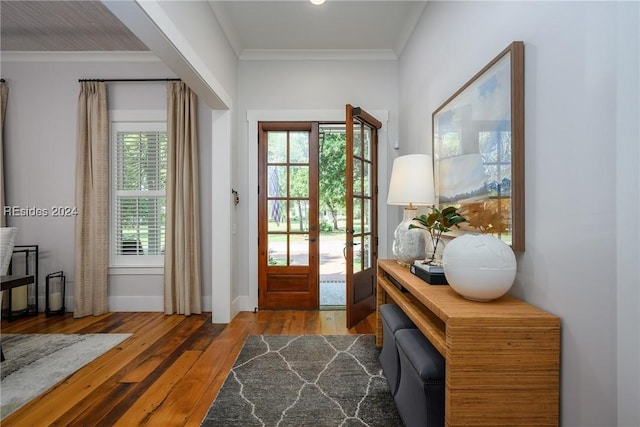 doorway with hardwood / wood-style floors and crown molding