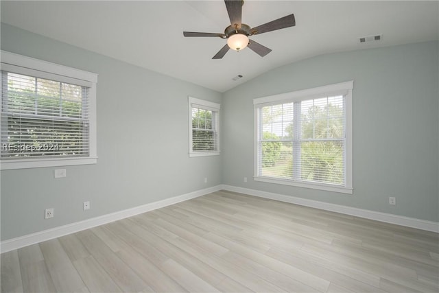 empty room with lofted ceiling, ceiling fan, and light wood-type flooring