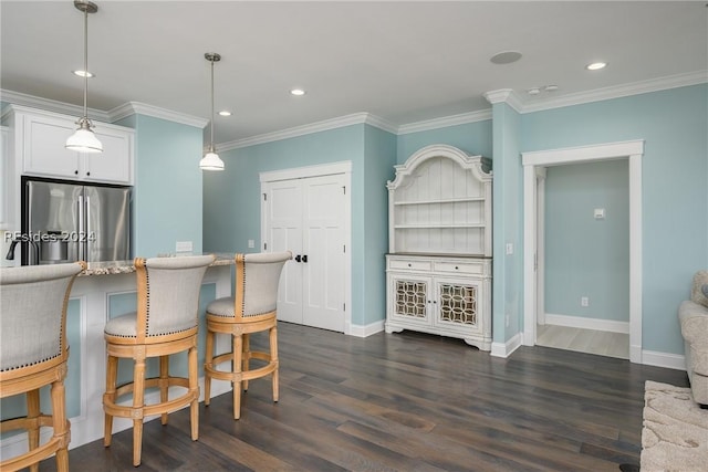 kitchen with crown molding, stainless steel fridge with ice dispenser, hanging light fixtures, dark hardwood / wood-style flooring, and white cabinets