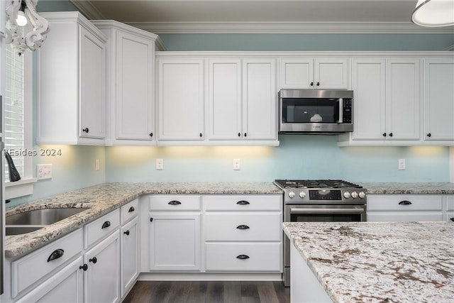 kitchen featuring stainless steel appliances, ornamental molding, dark wood-type flooring, and white cabinets