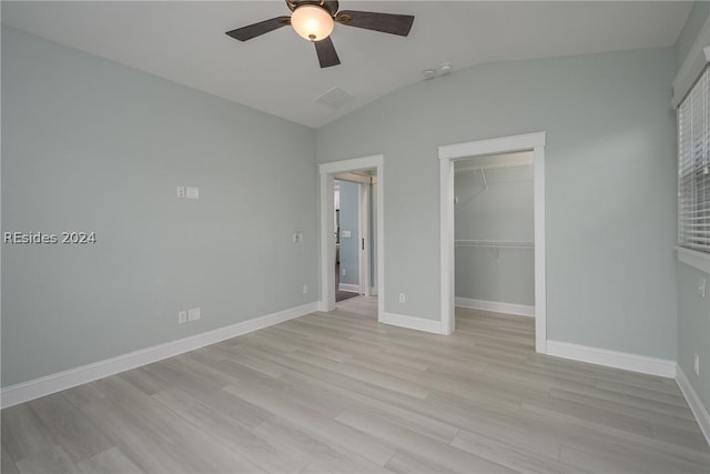 unfurnished bedroom featuring lofted ceiling, light hardwood / wood-style floors, a closet, and ceiling fan