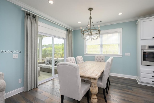 dining space featuring dark hardwood / wood-style flooring, crown molding, and a chandelier