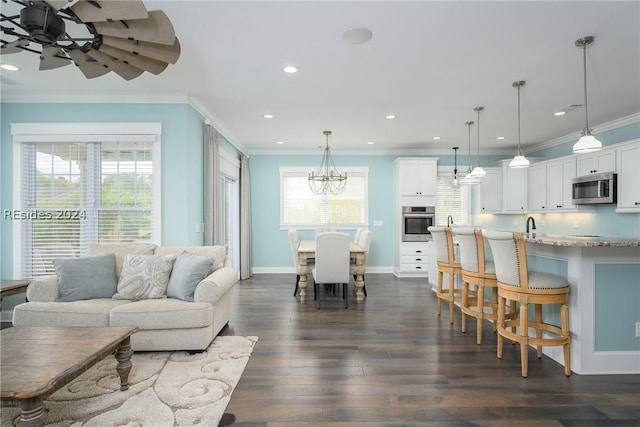 living room featuring crown molding, sink, ceiling fan with notable chandelier, and dark hardwood / wood-style flooring