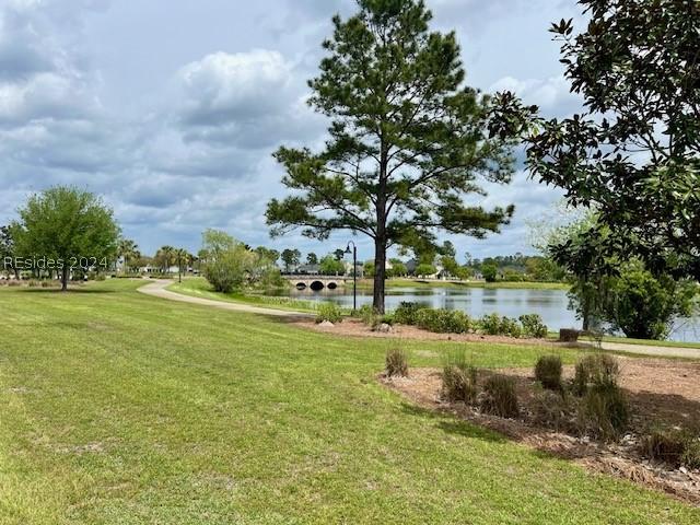 view of community featuring a water view and a lawn