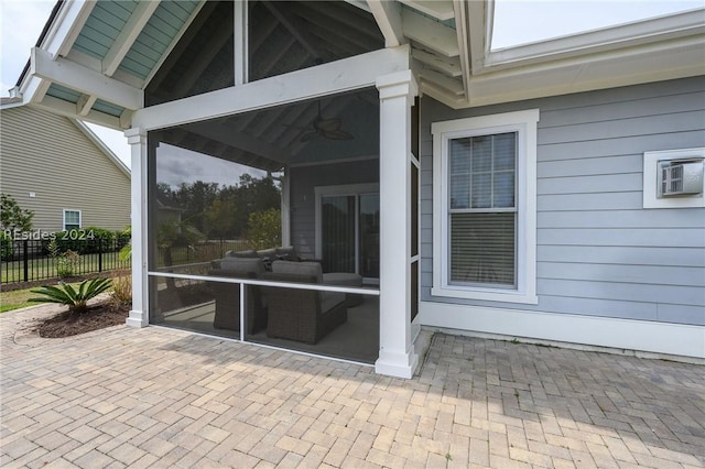 view of patio featuring ceiling fan and a sunroom