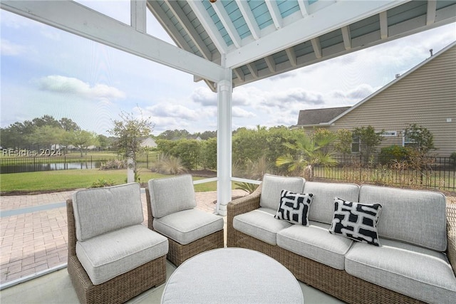 view of patio with a water view and outdoor lounge area