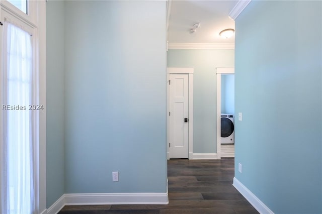 hall featuring crown molding, washer / dryer, and dark hardwood / wood-style floors