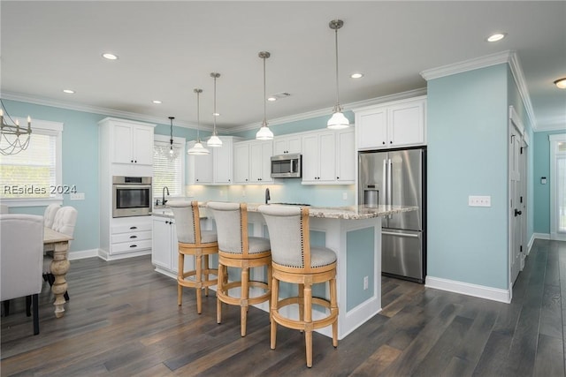 kitchen featuring stainless steel appliances, decorative light fixtures, a kitchen island, and white cabinets