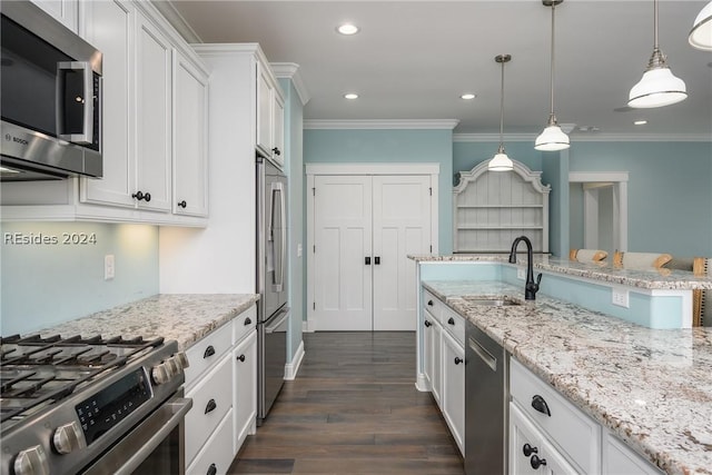 kitchen featuring sink, ornamental molding, appliances with stainless steel finishes, pendant lighting, and white cabinets