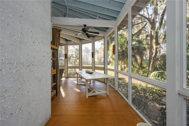 unfurnished sunroom with vaulted ceiling and ceiling fan