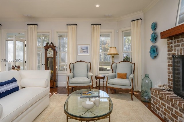 living room featuring ornamental molding, hardwood / wood-style floors, and a fireplace