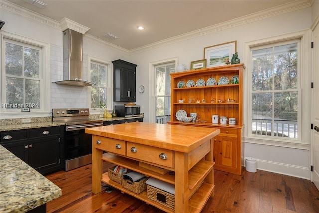 kitchen featuring stainless steel appliances, light stone countertops, dark hardwood / wood-style floors, and wall chimney range hood