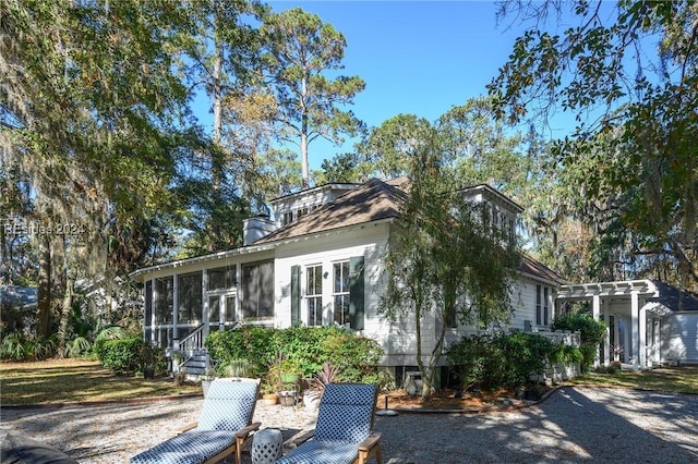 view of side of property featuring a sunroom