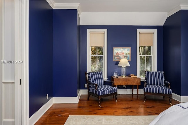 sitting room with hardwood / wood-style flooring and crown molding