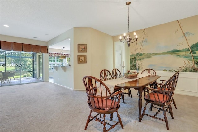 dining room with light carpet and a notable chandelier